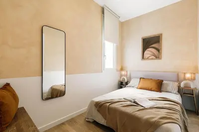 a living room with a couch and a table at Pontone - 2 bedrooms and balcony in Eixample Dreta in Barcelona