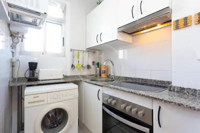 a kitchen with a washing machine and a sink at Bonito alojamiento cerca de Plaza España in Barcelona