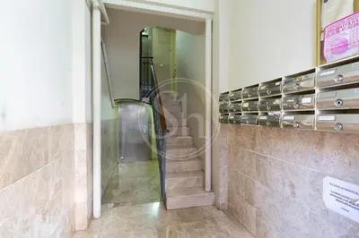 a staircase in a building with a glass door at Bonito alojamiento cerca de Plaza España in Barcelona