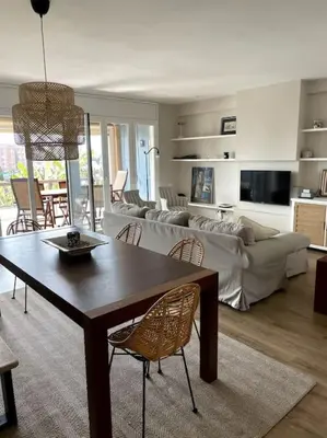a living room with a table and a couch at Apartment of 100m2 with sea views in Sant Vicenç de Montalt