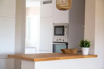 a kitchen with a wooden counter top with a plant at Apartment of 100m2 with sea views in Sant Vicenç de Montalt