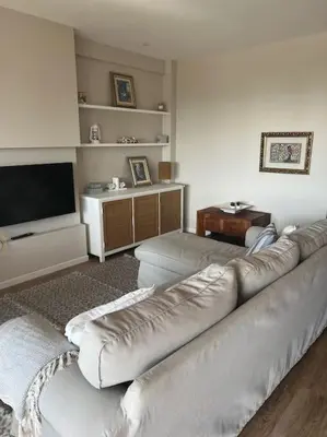 a living room with a couch and a flat screen tv at Apartment of 100m2 with sea views in Sant Vicenç de Montalt