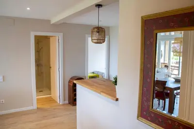 a kitchen with a table and a dining room at Apartment of 100m2 with sea views in Sant Vicenç de Montalt