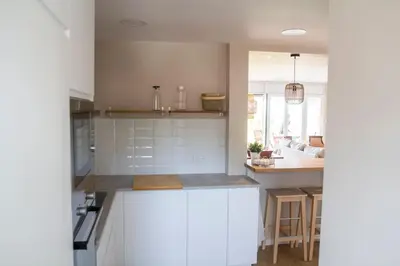 a kitchen with white cabinets and a counter top at Apartment of 100m2 with sea views in Sant Vicenç de Montalt