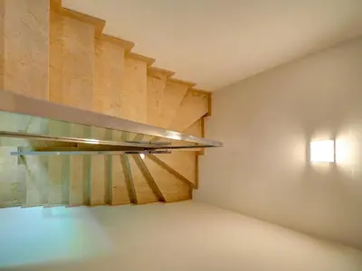 a room with a staircase with a glass shelf at La Perla by Hello Homes Sitges in Sitges