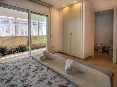 a bedroom with a large bed with towels on it at La Perla by Hello Homes Sitges in Sitges