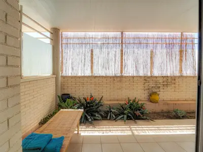 a room with a bench and a large window at La Perla by Hello Homes Sitges in Sitges