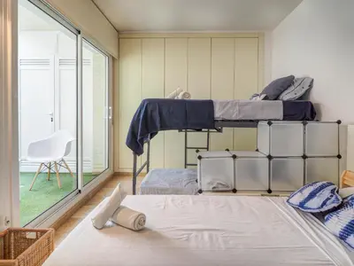 two bunk beds in a room with a window at La Perla by Hello Homes Sitges in Sitges