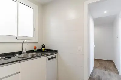 a white kitchen with a sink and a window at 4213 - AB Sagrada Familia Views VI-I in Barcelona