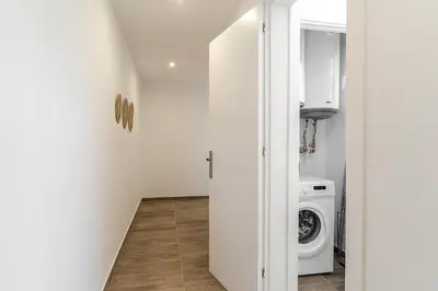 a white laundry room with a washer and dryer at 4213 - AB Sagrada Familia Views VI-I in Barcelona