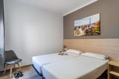 a bedroom with a white bed and a painting on the wall at 4213 - AB Sagrada Familia Views VI-I in Barcelona
