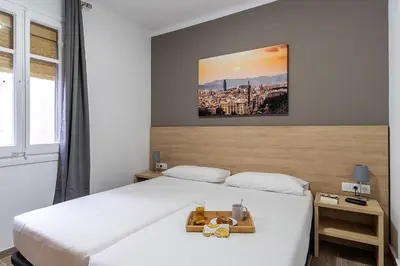 a hotel room with a bed with a tray of food on it at 4213 - AB Sagrada Familia Views VI-I in Barcelona