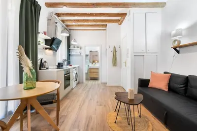 a living room with a couch and a table at Lodging Apartments Almirall Beach 31 in Barcelona