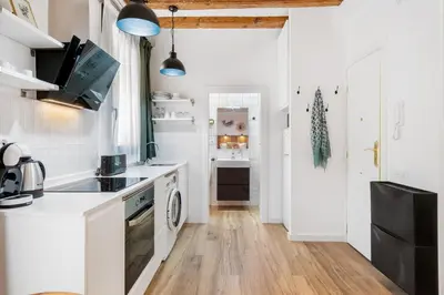 a kitchen with white counters and a stove top oven at Lodging Apartments Almirall Beach 21 in Barcelona