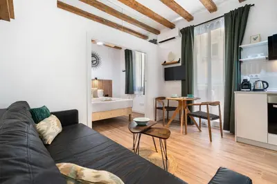 a living room with a couch and a table at Lodging Apartments Almirall Beach 21 in Barcelona