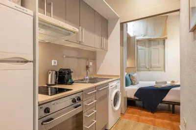 a kitchen with a sink and a washer and dryer at Stay U-nique Apartment Boters in Barcelona