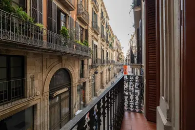 an alley in a city with buildings and a balcony at Stay U-nique Apartment Boters in Barcelona