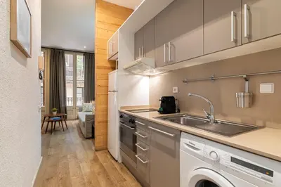 a kitchen with a sink and a washing machine at Stay U-nique Apartment Boters in Barcelona