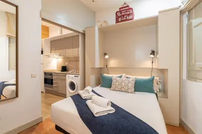 a bedroom with a large bed with towels on it at Stay U-nique Apartment Boters in Barcelona