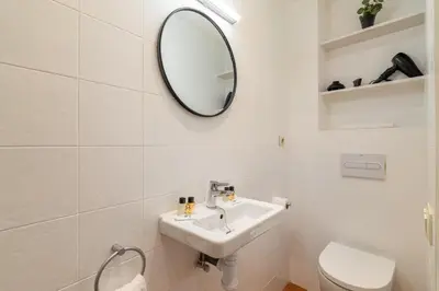 a white bathroom with a sink and a mirror at Stay U-nique Apartment Boters in Barcelona