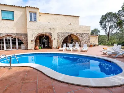 a swimming pool in front of a house at Holiday Home Can Trullas by Interhome in Viladecaballs
