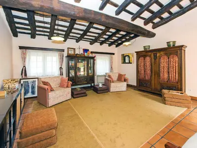 a large living room with couches and a wooden ceiling at Holiday Home Can Trullas by Interhome in Viladecaballs