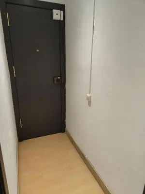 a room with a black door and a wooden floor at 029 Apartament 2-2 in Barcelona