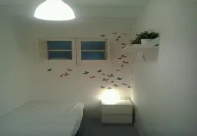 a bedroom with a bed and butterflies on the wall at 029 Apartament 2-2 in Barcelona