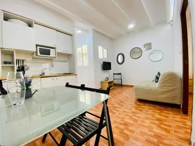 a kitchen and living room with a table and a couch at 030 apartameto 4-1 in Barcelona