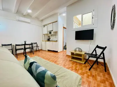 a living room with a couch and a tv and a table at 030 apartameto 4-1 in Barcelona