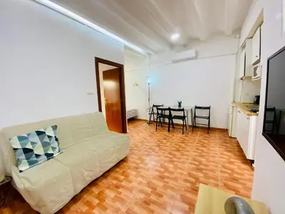 a living room with a bed and a table at 030 apartameto 4-1 in Barcelona