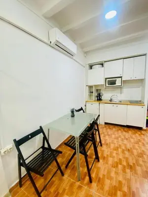 a kitchen with a table and chairs in a room at 030 apartameto 4-1 in Barcelona
