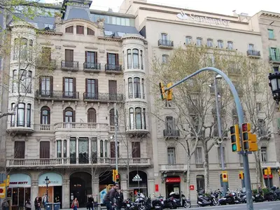 a large building on a city street with a traffic light at Apartment Plaza de Catalunya - Pso- de Gracia by Interhome in Barcelona