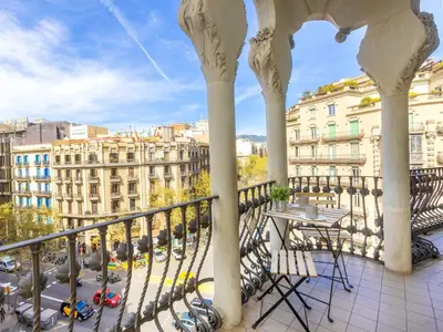 a balcony with a table and chairs and buildings at Apartment Eix-Dret-Roger de LLuria-Valencia by Interhome in Barcelona