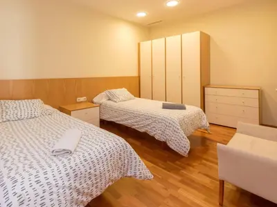 two beds in a room with wooden floors at Apartment Plaza Catalunya-Rda-Universidad by Interhome in Barcelona