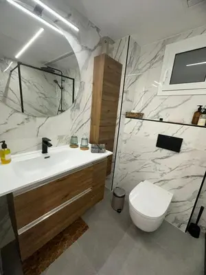a bathroom with a white sink and a toilet at Vidanova 2 in Vilanova i la Geltrú