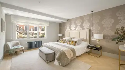 a bedroom with a large bed and a chair at Precioso Apartamento en Barcelona in Terrassa