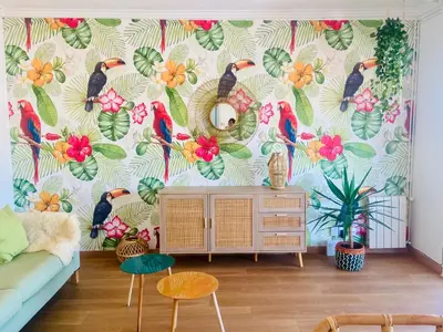 a living room with a wallpaper with birds and flowers at Tucan tropical in Sabadell