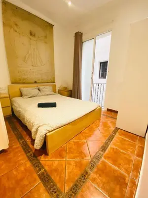 a bedroom with a bed and a large window at 022 Center Barca 1,1 in Barcelona