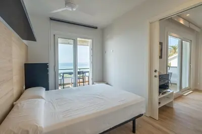 a bedroom with a bed and a view of the ocean at Sitges frente al mar in Sitges