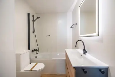 a bathroom with a toilet and a sink and a tub at Sitges frente al mar in Sitges
