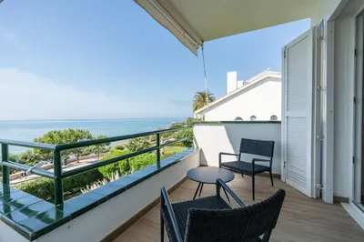 a balcony with chairs and a view of the ocean at Sitges frente al mar in Sitges