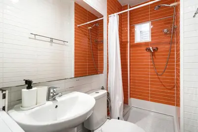 a bathroom with a toilet and a sink and a shower at Charming Beachside Apartment in Barceloneta in Barcelona