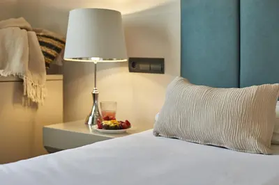 a bedroom with a bed with a lamp and a bowl of fruit at BBarcelona Rogent Flats in Barcelona