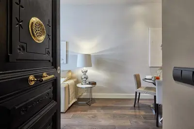 a room with a door and a chair and a table at BBarcelona Rogent Flats in Barcelona