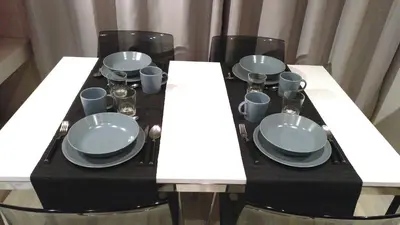 a dining table with plates and cups and plates andoverty at Apartamento 1 habitación cerca Sants-Estación in Barcelona