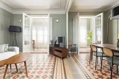 a living room with a couch and a table at Spacious Stylish 4-bedroom Modernist Apartment in Barcelona