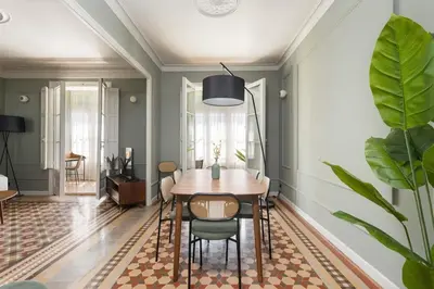 a dining room with a table and chairs at Spacious Stylish 4-bedroom Modernist Apartment in Barcelona