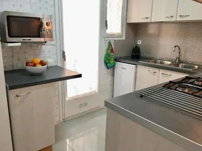 a kitchen with a bowl of fruit on a counter at Apartamento La Mediterránea a 100 metros de la playa - Vilanova i la Geltrú - ES-332-1 in Vilanova i la Geltrú