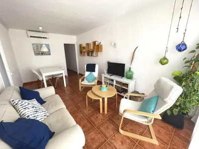 a living room with a white couch and chairs at Apartamento La Mediterránea a 100 metros de la playa - Vilanova i la Geltrú - ES-332-1 in Vilanova i la Geltrú